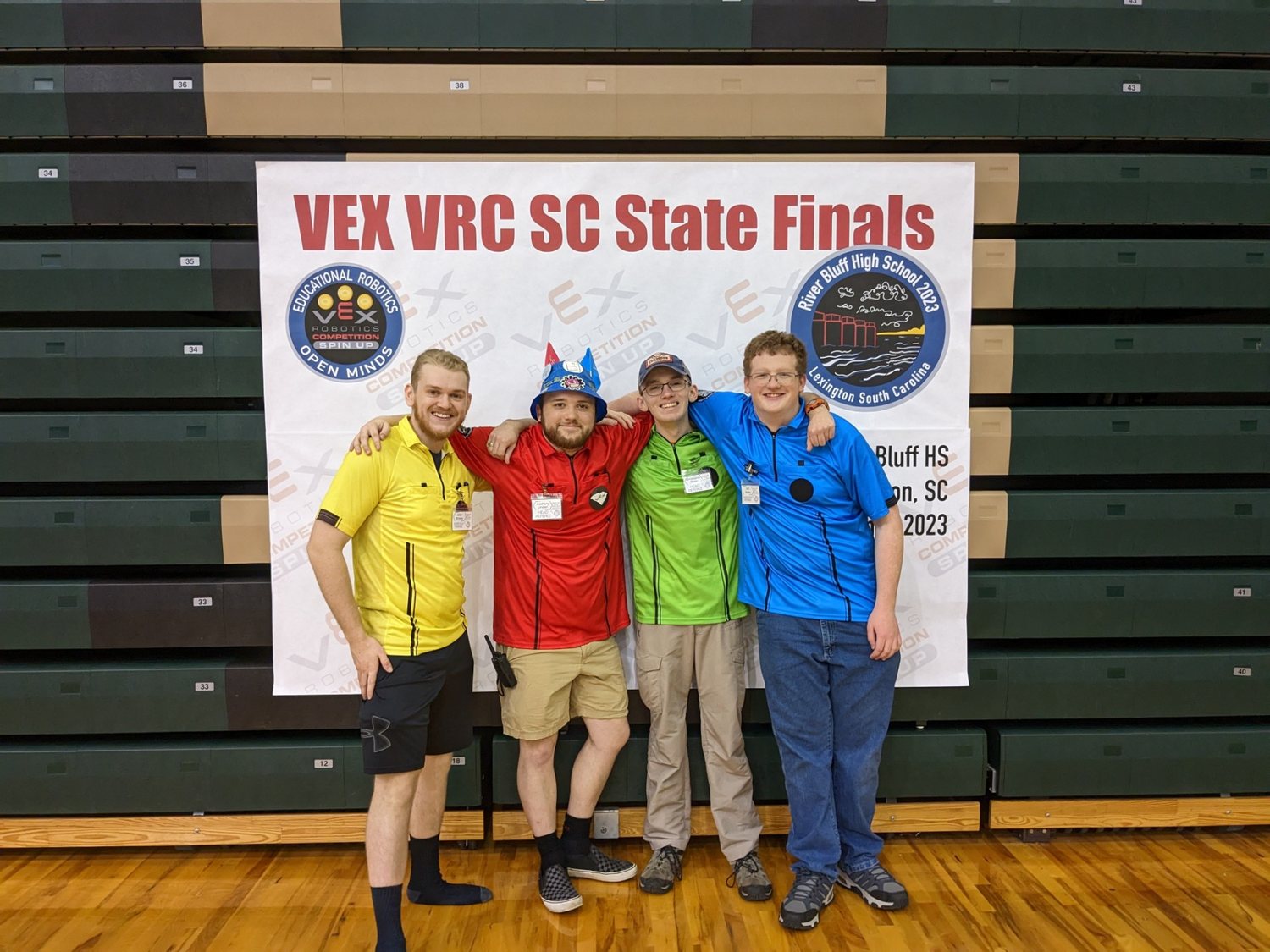 Four robotics competition volunteers together at the 2023 South Carolina State Finals